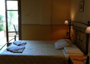 A bed or beds in a room at Alexandros Studios & Apartments