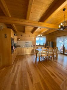 a kitchen and dining room with a table and chairs at Nowica 71 Dom Jodłowy in Nowica +12 photos