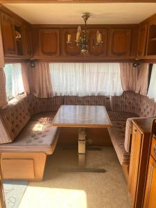 a table in the back of an rv with a table at Camping Rogowo in Mrzeżyno