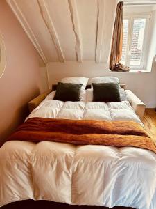 a large white bed in a room with a window at Lovely flat 20min from Champs Élysée, 10min from Stade de France in Saint-Denis