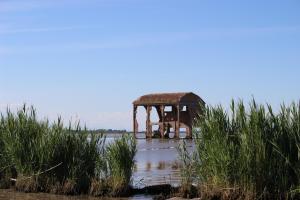 an old structure in the middle of a body of water at Casa Giulia in Santa Giulia