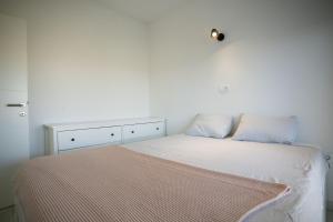 a bedroom with a bed with a white wall at Lucas apartment in Čapljina