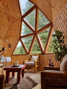 a living room with a large window in a wooden ceiling at ANGEL DOMO in Puerto Montt
