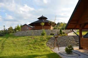 a building with a gazebo in a yard at Nowica 71 Dom Jodłowy in Nowica
