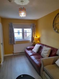 a living room with a couch and a window at 4 Bleach Green Apartments in Ballycastle