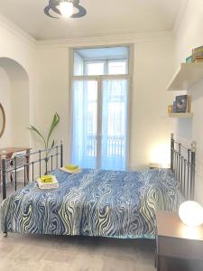 a bedroom with a zebra print bed in front of a window at Anselmo Max in Turin