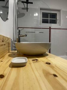 a bowl on top of a wooden counter in a bathroom at Gîte L’Erable in Haverskerque