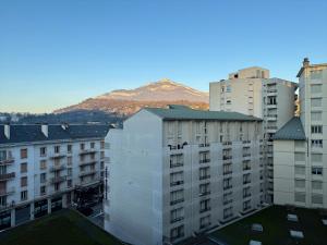 a group of buildings with a mountain in the background at Logement Autour de Moi * * * * * in Chambéry