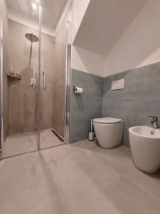 a bathroom with a shower and a toilet and a sink at Casa Delle Volte Perugia in Perugia