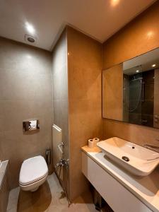a bathroom with a white toilet and a sink at fabuleux S2 a la Marsa in La Marsa