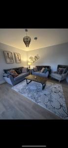 a living room with two couches and a coffee table at Home in Kilmuckridge in Wexford