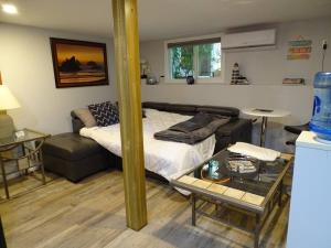 a living room with a bed and a couch at Trails End Beach house suite w/hot tub in Ladysmith