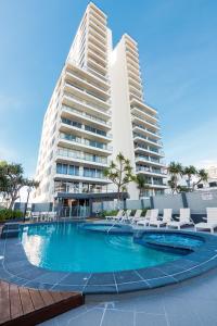 a swimming pool in front of two tall buildings at The Penthouses Apartments in Gold Coast