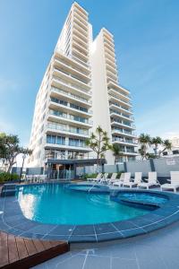 a large swimming pool in front of a large building at The Penthouses Apartments in Gold Coast