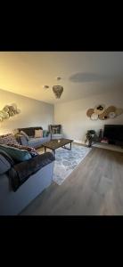 a living room with a couch and a table at Home in Kilmuckridge in Wexford