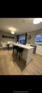 a kitchen with a table and chairs in a room at Home in Kilmuckridge in Wexford