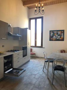 a kitchen with a table and a table and chairs at palazzo piazza centrale in Bagnacavallo