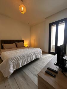 a bedroom with a bed and a television in it at Joli S2 a la Marsa in La Marsa