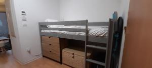 a small room with a bunk bed and a room with a bed at Appartement de l'Isard Bleu, dans résidence de tourisme 3 étoiles in Lourdes