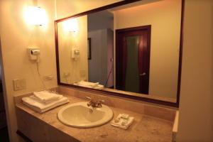 a bathroom with a sink and a large mirror at Hotel Martell in San Pedro Sula +42 photos