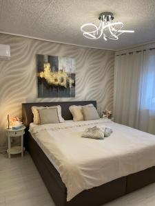 a bedroom with a large bed with white sheets at Alia house with garden in Piešťany in Piešťany