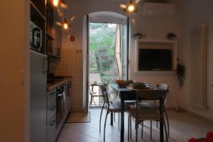 een keuken met een tafel en stoelen en een raam bij Il Nido di Marirò in La Spezia