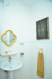 a bathroom with a sink and a mirror at La Neisha Hotel Zanzibar in Stone Town