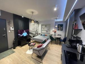 un soggiorno con divano e TV di New comfortable apartment with balcony and sauna on Klimieckiego street a Cracovia