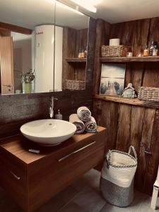 a bathroom with a sink and a mirror at Chalet Sträba in Bellwald