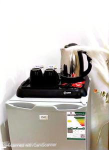 a tea kettle sitting on top of a refrigerator at استديو بأثاث انيق -النقرة in Hail