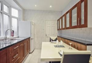 een grote keuken met een wastafel en een koelkast bij 1 bedroom flat with 3 beds,Luton Town and station F3 53 in Luton