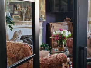 a living room with a couch and a vase of flowers at Flawsome stays Unique Edwardian Home near the Harbour and town perfect for Families up to 8 guests in Ramsgate