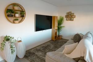 a living room with a couch and a flat screen tv at Casa do Carriço in Peso da Régua