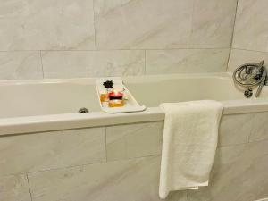 a bathroom with a bath tub with a tray of candles at Glamorous Palace with spa bath in North Shields