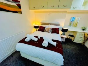 a bedroom with a large bed with two pillows at Glamorous Palace with spa bath in North Shields