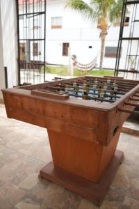 a wooden foosball table sitting on a tile floor at La Arteza Pacasmayo in Pacasmayo