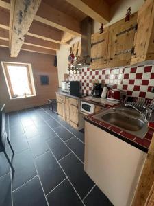 a kitchen with a sink and a counter top at L’appart du centre in Le Biot