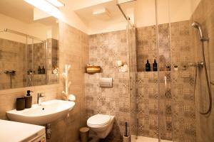 a bathroom with a shower and a toilet and a sink at Lomená Apartment - Free Garage in Košice