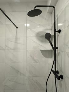 a shower with a glass door in a bathroom at Restoran&Motel and apartmants Lovacka prica in Tešanj