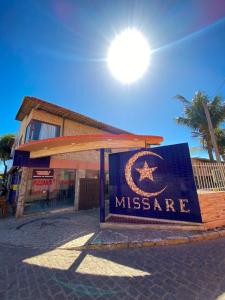 a sign for a museum in front of a building at Pousada Missare in Canoa Quebrada