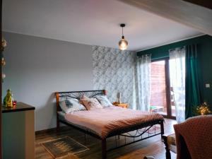 a bedroom with a bed with pillows on it at Izerska Zagroda in Świeradów-Zdrój