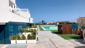 a view of a building with a swimming pool at Palmview Poolside Heaven in Turquesa del Mar in Orihuela Costa