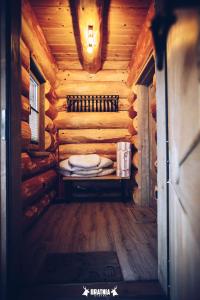 a room in a log cabin with a bed in it at Bratnia Bystre in Bystre