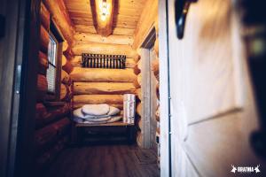 a small room in a log cabin with a bed at Bratnia Bystre in Bystre