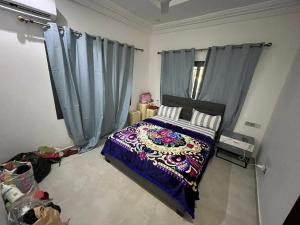 a bedroom with a bed with blue curtains at CASA de JAJA 