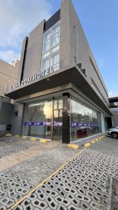 a building with a car parked in front of it at EL SHADDAI HOTEL in João Pessoa