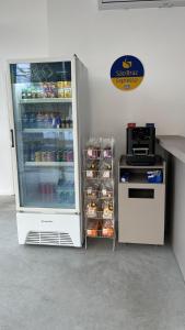 a refrigerator with food inside of it next to a stove at EL SHADDAI HOTEL in João Pessoa