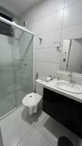 a bathroom with a shower toilet and a sink at EL SHADDAI HOTEL in João Pessoa
