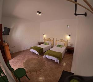 a room with two beds in a room at Casa Rural Muchichafe in Puerto del Rosario