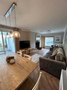 a living room with a couch and a table at Applestow Cottage in Northam